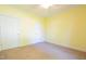 Carpeted bedroom featuring neutral colored walls, and two doors at 627 Carraway Dr, Graham, NC 27253