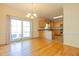 Open dining area with hardwood floors, light fixture, and sliding glass doors to outdoor space at 627 Carraway Dr, Graham, NC 27253