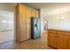 Bright, open kitchen featuring stainless refrigerator and view into the living areas at 627 Carraway Dr, Graham, NC 27253