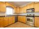 Bright kitchen featuring stainless steel appliances, light wood cabinetry and a neutral countertop at 627 Carraway Dr, Graham, NC 27253