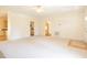 Spacious living room with neutral carpeting and access to kitchen, dining, and front door at 627 Carraway Dr, Graham, NC 27253