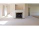 Living room showing fireplace and mantle, neutral color walls, and carpet at 627 Carraway Dr, Graham, NC 27253