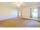 Spacious carpeted main bedroom has a ceiling fan and two windows at 627 Carraway Dr, Graham, NC 27253