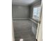 Bedroom with gray walls, white trim, tile flooring, and a large window at 6283 Harrisontown Rd, Rocky Mount, NC 27804