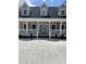 Close up of the full front porch and front door of this charming tan home at 6283 Harrisontown Rd, Rocky Mount, NC 27804