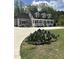 Beautiful tan home with a full front porch, mature trees, and concrete driveway at 6283 Harrisontown Rd, Rocky Mount, NC 27804