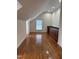 An empty room is a blank canvas with hardwood floors and a small sink and cabinet area at 6283 Harrisontown Rd, Rocky Mount, NC 27804