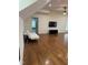 Cozy room with hardwood floors, television set and white futon ready to be personalized at 6283 Harrisontown Rd, Rocky Mount, NC 27804