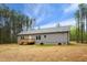 Back exterior showing newly constructed home with wood deck and lush green surroundings at 6312 Briddle Dr, Wendell, NC 27591