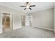 Carpeted bedroom boasts a ceiling fan, with an open door to a closet and bathroom at 6312 Briddle Dr, Wendell, NC 27591