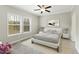 Serene bedroom with a plush bed, soft lighting, and large windows offering scenic views of the outdoors at 6312 Briddle Dr, Wendell, NC 27591