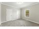 Carpeted bedroom featuring recessed lighting, one window and two doors at 6312 Briddle Dr, Wendell, NC 27591