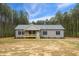 Inviting single-story home with gray vinyl siding, a covered porch, black shutters, and a well-maintained yard at 6312 Briddle Dr, Wendell, NC 27591