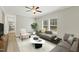 Inviting living room featuring a stylish sofa, a comfortable chair, and large windows providing abundant natural light at 6312 Briddle Dr, Wendell, NC 27591