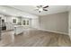 Bright open-concept living room and kitchen featuring hard surface floors and modern appliances at 6312 Briddle Dr, Wendell, NC 27591