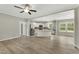 Bright open-concept living room and kitchen featuring hard surface floors and modern appliances at 6312 Briddle Dr, Wendell, NC 27591