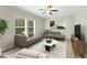 Comfortable living room with a plush rug, modern sofas, and large windows offering natural light and a peaceful ambiance at 6312 Briddle Dr, Wendell, NC 27591