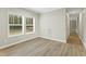 Bright living room with two windows offering natural light and modern hard surface flooring at 6312 Briddle Dr, Wendell, NC 27591