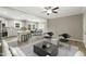 Open-concept living area showcases stylish furniture, a ceiling fan, and seamless transition to the kitchen and dining area at 6312 Briddle Dr, Wendell, NC 27591