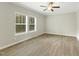 Bright living room with two windows offering natural light and modern hard surface flooring at 6312 Briddle Dr, Wendell, NC 27591