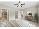 Bright main bedroom featuring a ceiling fan, ensuite bathroom, and a spacious walk-in closet at 6312 Briddle Dr, Wendell, NC 27591