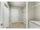 Spacious mud room with wood-look floors, shelving and white cabinets with marble countertops at 6312 Briddle Dr, Wendell, NC 27591