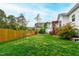 Expansive backyard featuring lush green lawn, mature trees, and beautiful landscaping at 6819 Franklin Heights Rd, Cary, NC 27518