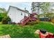 Well-maintained backyard featuring a deck, mature trees, and outdoor seating area at 6819 Franklin Heights Rd, Cary, NC 27518
