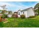 Spacious backyard with lush green grass, mature trees, and a cozy deck perfect for entertaining at 6819 Franklin Heights Rd, Cary, NC 27518