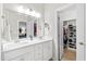 Bathroom with a double sink vanity, a large mirror, and access to a walk-in closet at 6819 Franklin Heights Rd, Cary, NC 27518