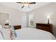 Comfortable bedroom featuring a ceiling fan, two windows, and wood dressers offering a relaxing retreat at 6819 Franklin Heights Rd, Cary, NC 27518
