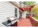 View of the outdoor deck featuring a stainless steel grill, pergola, and access to the yard at 6819 Franklin Heights Rd, Cary, NC 27518