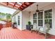 Inviting outdoor deck area with a ceiling fan, string lights, and comfortable seating arrangement at 6819 Franklin Heights Rd, Cary, NC 27518