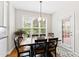 Bright dining area with a wooden table, chandelier, and large window overlooking the backyard at 6819 Franklin Heights Rd, Cary, NC 27518