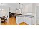 Open-concept kitchen with gray countertops and white cabinets, seamlessly connected to the dining and living areas at 6819 Franklin Heights Rd, Cary, NC 27518