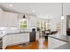 Spacious kitchen with white cabinetry, stainless steel appliances, dark countertops, and an adjacent dining area at 6819 Franklin Heights Rd, Cary, NC 27518