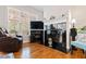 Cozy living room with a fireplace, hardwood floors, and large windows for natural light at 6819 Franklin Heights Rd, Cary, NC 27518