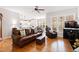 Open-concept living room and kitchen featuring hardwood floors, modern appliances, and ample seating at 6819 Franklin Heights Rd, Cary, NC 27518