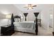 Comfortable main bedroom with a ceiling fan, two windows with dark curtains, and carpet floors at 6819 Franklin Heights Rd, Cary, NC 27518