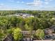 This aerial shot highlights the community surrounded by a mature forest and a peek of downtown at 708 Martin Luther King Jr. Blvd # E2, Chapel Hill, NC 27514