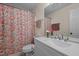 Bathroom with modern vanity, mirror and red floral curtain at 708 Martin Luther King Jr. Blvd # E2, Chapel Hill, NC 27514