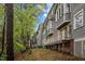 Exterior showcasing the residence's architectural design complemented by mature trees at 708 Martin Luther King Jr. Blvd # E2, Chapel Hill, NC 27514