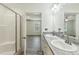 Ensuite bathroom featuring granite counters, double sinks, and a walk-in shower at 7120 Guess Rd, Hillsborough, NC 27278
