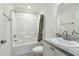 Bathroom featuring a tub/shower combo and a vanity with a granite-look countertop at 7120 Guess Rd, Hillsborough, NC 27278