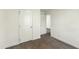 Bedroom featuring neutral walls and carpet with 2 doors and a window at 7120 Guess Rd, Hillsborough, NC 27278
