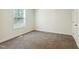Cozy bedroom with a neutral color scheme, plush carpeting, and bright natural light at 7120 Guess Rd, Hillsborough, NC 27278