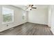 This bedroom features two large windows offering plenty of natural light and vinyl flooring at 7120 Guess Rd, Hillsborough, NC 27278