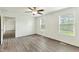 Bright bedroom with neutral walls, two windows, and modern vinyl flooring at 7120 Guess Rd, Hillsborough, NC 27278