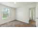 Bedroom with neutral walls and carpet, featuring a window for lots of natural light at 7120 Guess Rd, Hillsborough, NC 27278