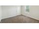 Cozy bedroom featuring neutral walls, carpet, and a window for natural light at 7120 Guess Rd, Hillsborough, NC 27278